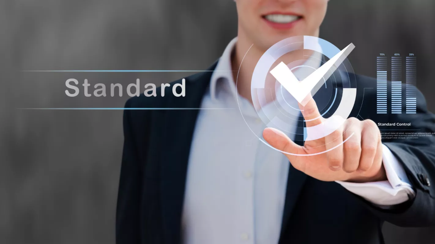 Businessman using touch-screen interface for standard control metrics.