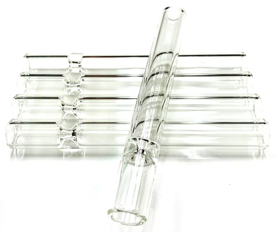 Organized set of eight unused glass test tubes on reflective surface.