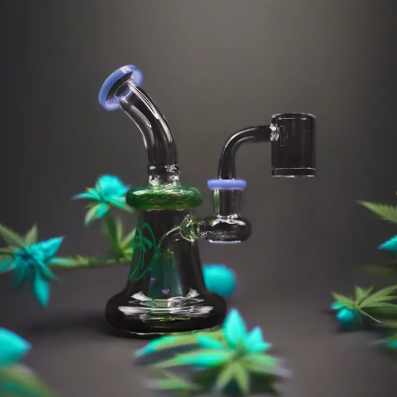 Striking black and green glass bong with percolator and blue mouthpiece on gray background.