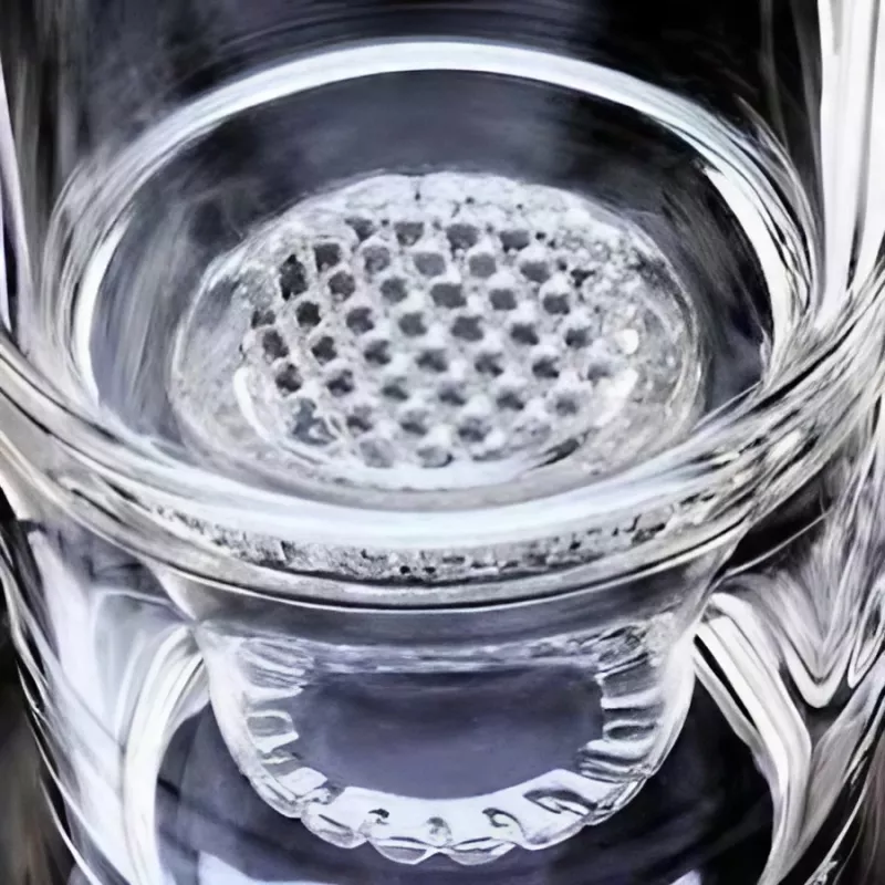 Intricate honeycomb-patterned glass with reflective curved walls, showcasing craftsmanship.
