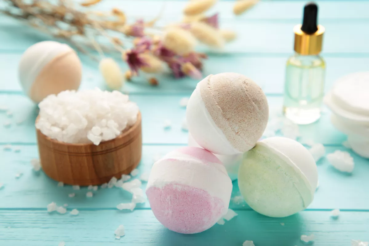 Spa essentials with colorful bath bombs, sea salt, and aromatic accessories for relaxation.