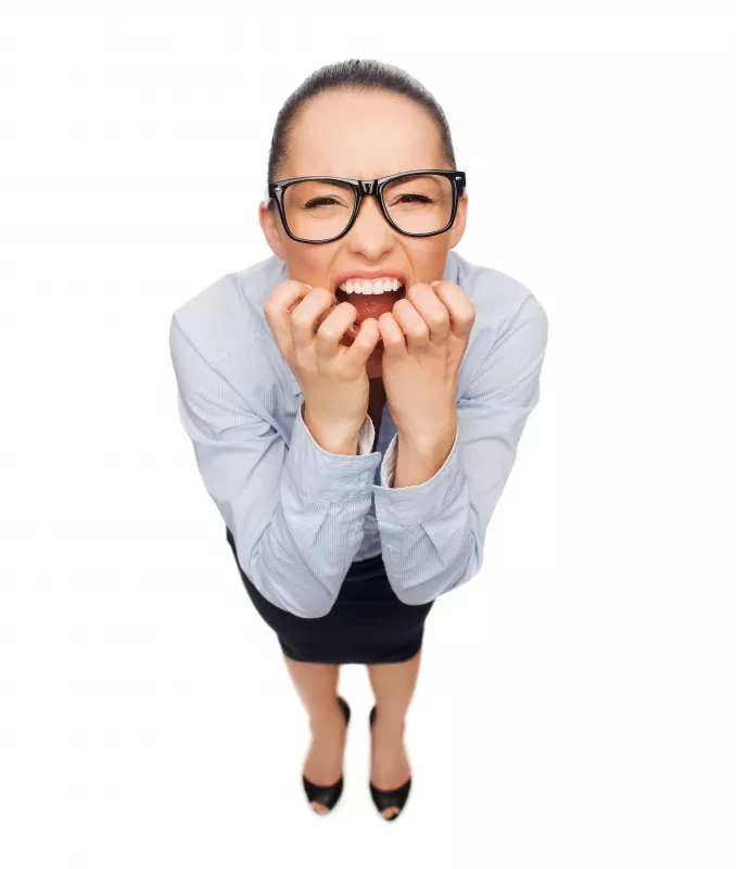 Stressed businesswoman considers CBD for anxiety relief in office attire.