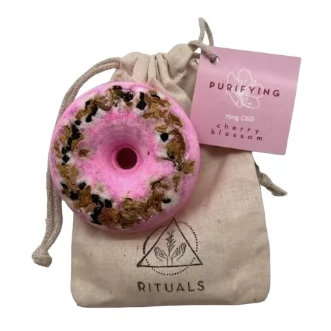 Purifying CBD bath bomb with cherry blossom scent and drawstring bag.