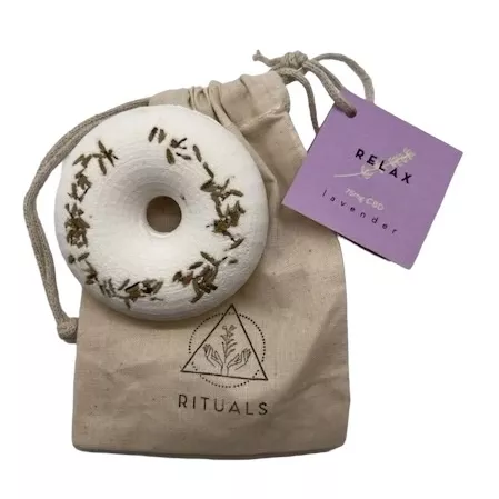 Aromatherapy lavender ring with CBD on a beige pouch.