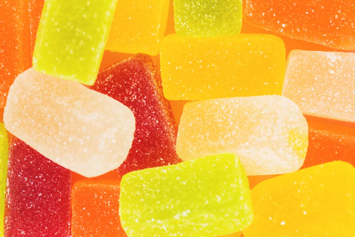 Colorful assortment of gummy candies with sparkling sugar coating.