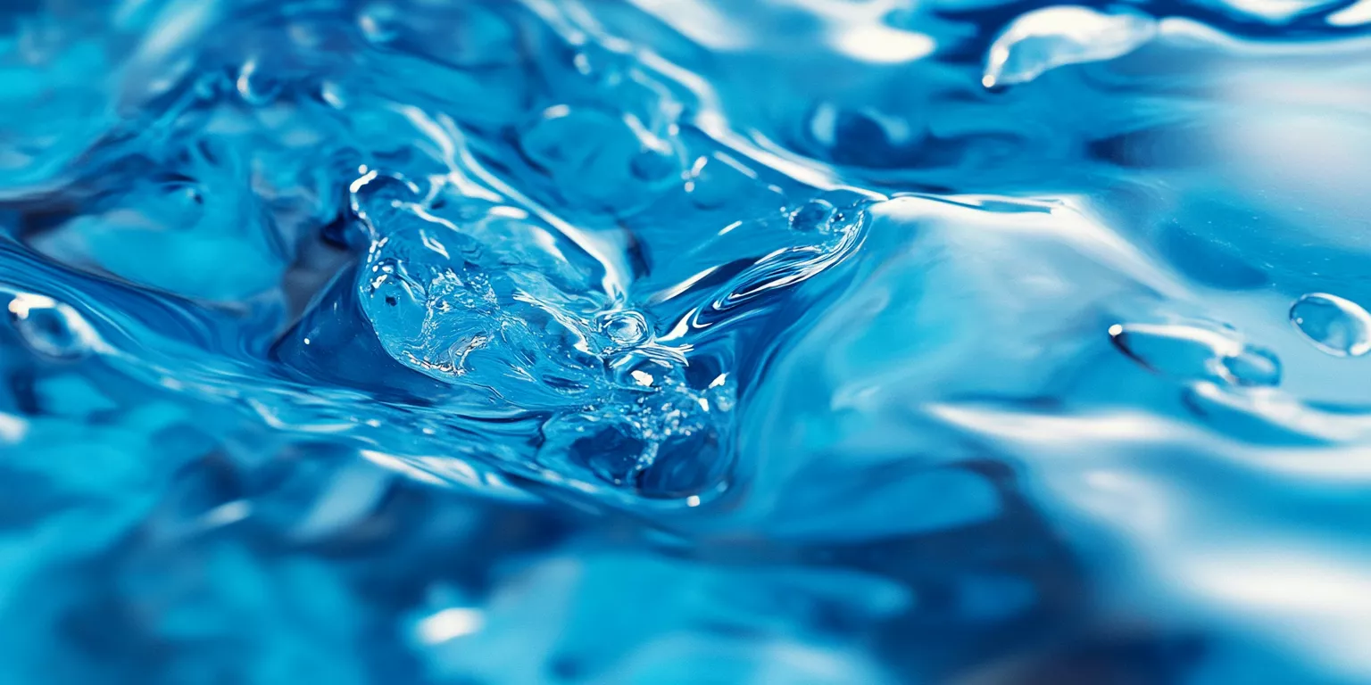 Close-up of vibrant blue water surface with ripples, bubbles, and light reflections.