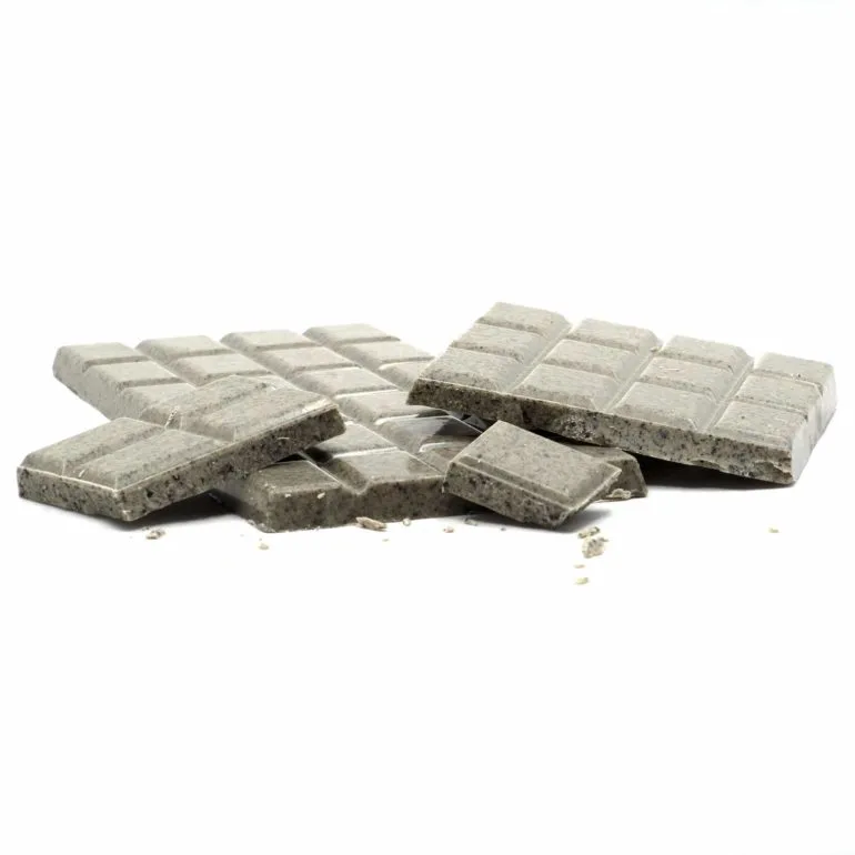 Broken dark chocolate bar with cookie crumbs on white background.