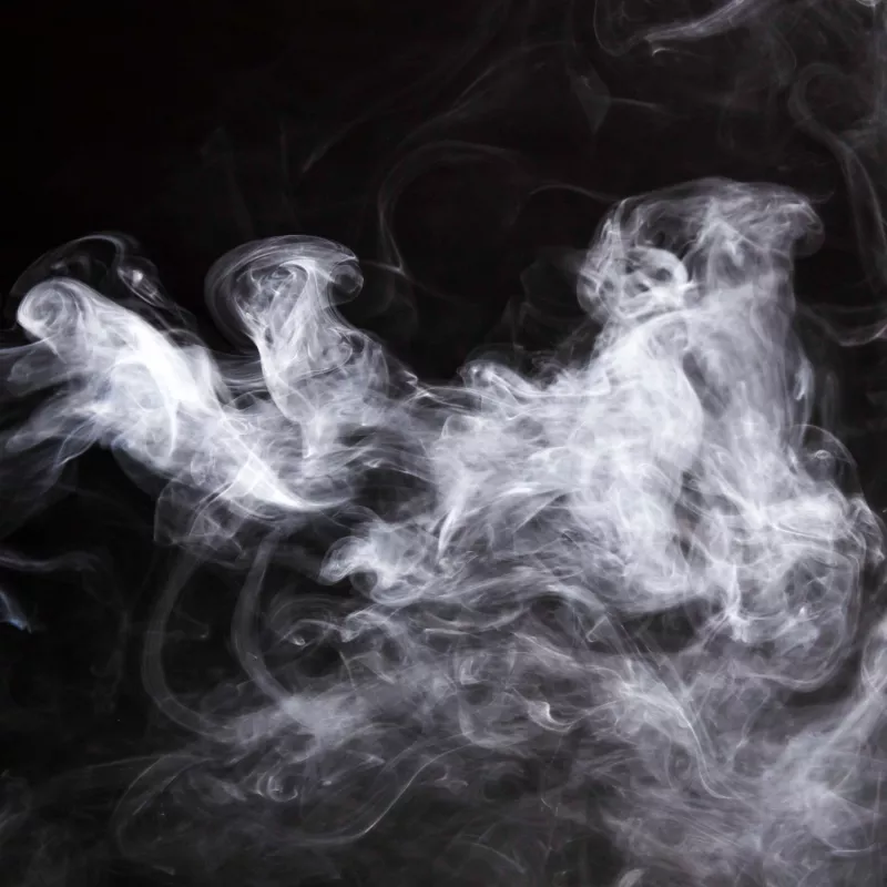 Ethereal white smoke swirls captured in dynamic patterns against a dark background.